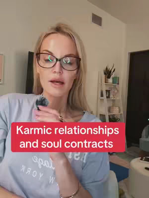 A woman with blonde hair and glasses is speaking into a microphone. A red rectangular box with white text reading 'Karmic relationships and soul contracts' overlays this woman, likely setting the topic of the video.