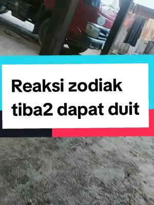 The image has a background featuring a partially visible red vehicle and what appears to be a concrete surface. Overlaid on this is a rectangular text box with a cyan and black gradient, upon which the white text 'Reaksi zodiak tiba2 dapat duit' is displayed.