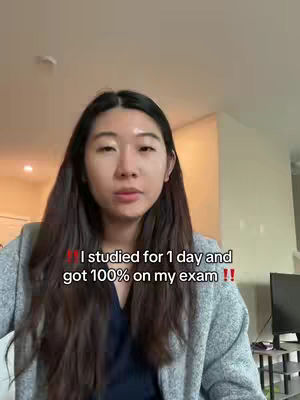 A young woman with long dark hair is centered in the frame against a soft-focus background. She is wearing a gray, oversized jacket over a blue top. Text overlays indicate she studied for one day and got a perfect score on a test.