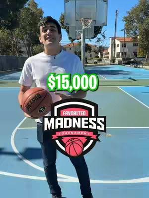 A man in a white t-shirt stands on a basketball court, holding a basketball. A large graphic overlay declares '$15,000' and the words 'FAVORITED MADNESS TOURNAMENT'. The background includes a basketball hoop, buildings, and trees under a clear sky.