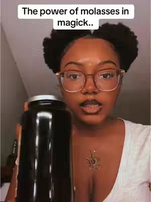 A woman with glasses holds a bottle of molasses. Text overlayed on the image reads "The power of molasses in magick..".