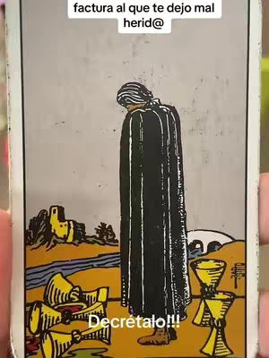 The image is a tarot card illustration featuring a figure in a dark robe standing with their back to the viewer, a symbol of mourning or contemplation. The composition places the figure in the center, with a collection of overturned goblets in the foreground, suggesting loss and sorrow. The card is set against a background of a subtle landscape and building formations, and has text overlayed.