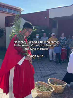 A man in a red robe holds palm branches, standing in front of a group of people. Text overlayed on the image reads a Bible verse.