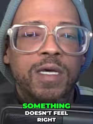The cover image is a close-up shot of a man's face. He is wearing glasses with clear frames and a light blue beanie. overlay text in a green box at the bottom of the frame.