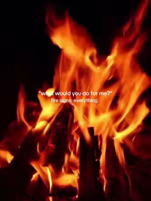A close-up shot focuses on a blazing fire, with flames of orange and red filling the frame. The fire is in the foreground, with dark and blurred elements providing backdrop. Text in white is overlaid on the flames, with a caption about fire signs.