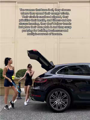 The cover image shows two women, likely tennis players, standing near a black Porsche SUV with the trunk open. The women are in athletic attire, holding tennis racquets and balls. The background includes a building facade. Text overlays provide motivational context.