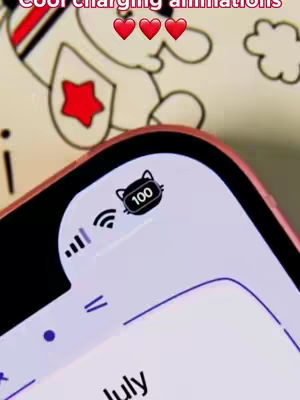 The image shows a close-up of a phone screen. The top of the screen displays a battery icon stylized with a cat face, indicating 100% charge. Above it, text reads 'Cool charging affirmations' with three heart emojis. The background has a partially visible illustration of a smiling figure with a star and a cloud to the right.