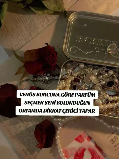 A top-down shot showcasing a collection of jewelry and accessories arranged on a textured surface. A silver box is slightly ajar, overflowing with pearls and other items. A red rose and petals are scattered on the surface, along with a label and other decorative items. The overall scene creates a luxurious and aesthetic vibe.