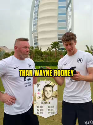 The cover image shows two men in white shirts, with a football card and a famous building in the background.