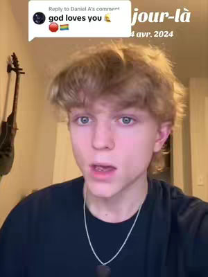 A young man with light blonde hair is centered in the frame, his expression open-mouthed as if speaking. A comment bubble floats above, and a caption displays text with a date.