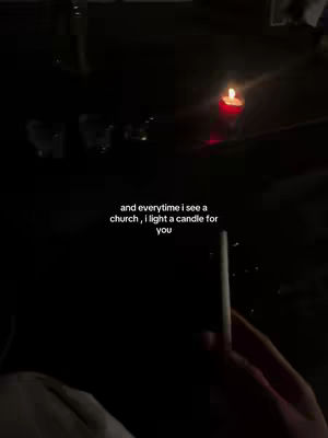 The cover image depicts a dimly lit scene with a lit candle in the background. The text overlay is positioned centrally, with a hand holding a slim, white object in the foreground.