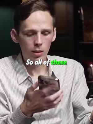 A young man in a striped shirt holds a dark-colored smartphone, with the text overlayed, positioned in the center, over the top part of his body and head.