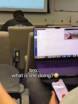 The image is taken from a first-person perspective and shows a laptop on the left focus while a smartphone is in use on the right. The laptop screen is displaying a video, and a person is looking at the laptop. The hook text is added at the bottom of the image, with a blurred background of a classroom setting.