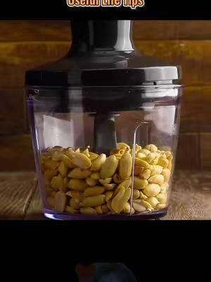 The image shows a close-up of a blender filled with peanuts, ready to be ground. Above, the text overlay says 'Useful Life tips'.