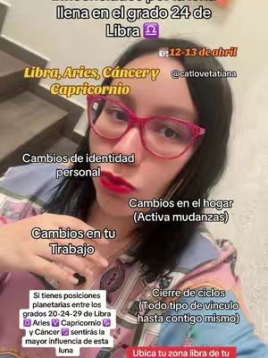 A selfie-style image featuring a fair-skinned woman with long black hair and pink-framed glasses. She wears red lipstick and a patterned top with a pink and blue palette. Text overlays provide astrological information, including key phrases and dates.