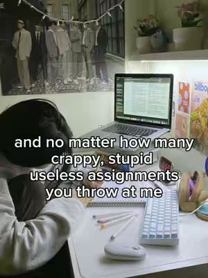 The cover image shows a person hunched over a desk with a laptop, keyboard, pens, and other items. The person's face is mostly obscured by their hair, desk setup includes a laptop with a lit screen, a keyboard, mouse, and pens. The background features a poster and a shelf.