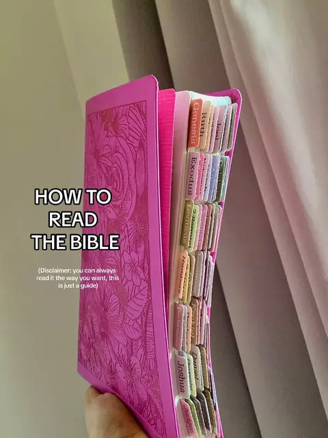 A close-up shot showcases a vibrant pink Bible held open, revealing labeled pages with book names like 'Genesis' and 'Exodus'. The cover is adorned with floral patterns. Text overlays read 'HOW TO READ THE BIBLE' and a disclaimer.