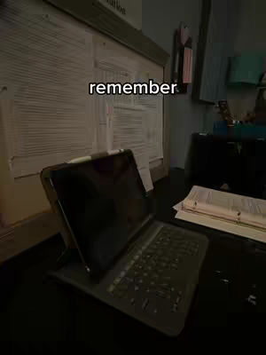 The cover image shows a desk with an open laptop in front of it. On the wall behind the desk, there's a whiteboard covered in handwriting, and there are a few other objects arranged along the edge of the desk. The primary color of the walls is a light gray. The laptop's screen is dark. The overall feel suggests a study or workspace.