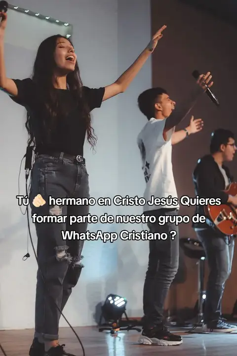A group of three people singing on stage in front of a white backdrop. The main subject is a young woman singing with her arms raised; text is overlaid on the image.