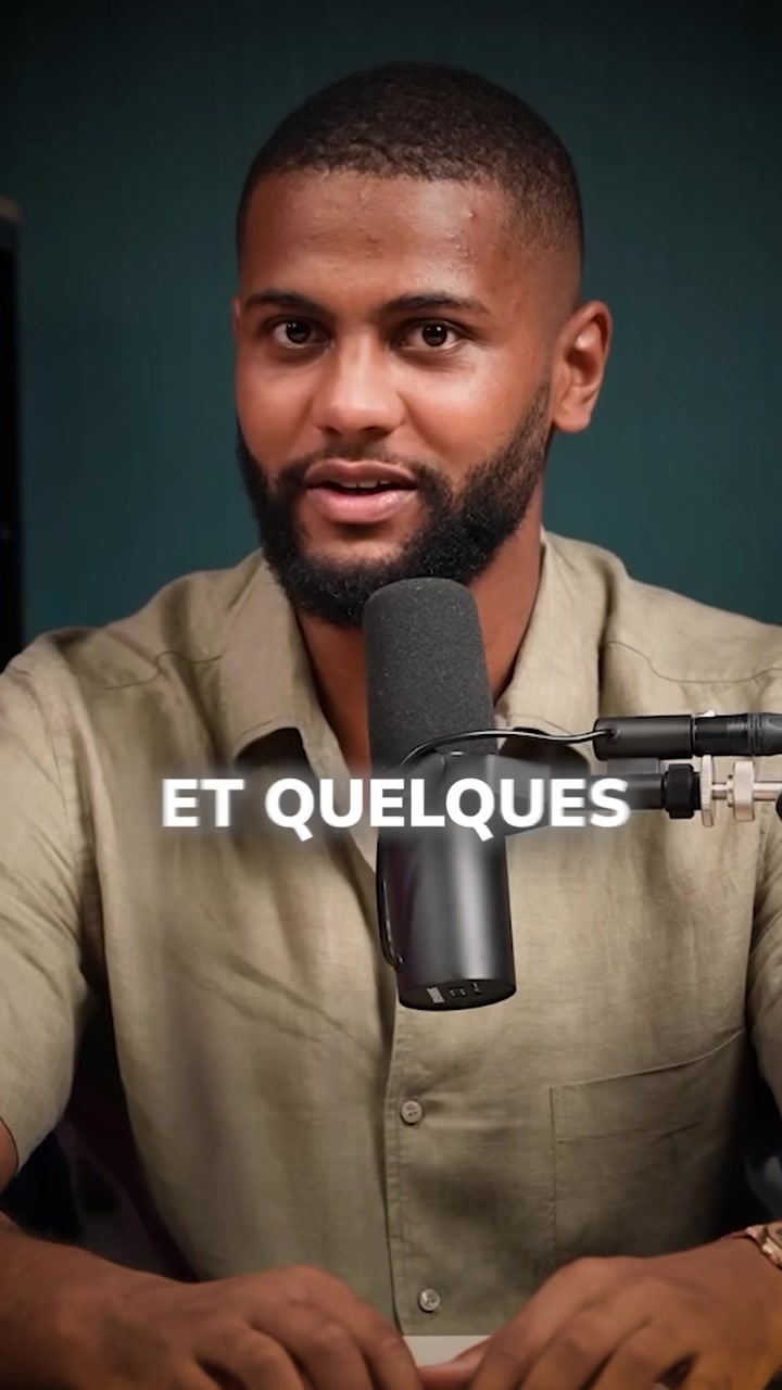 A man with a dark beard and short hair is centered in the frame. He's wearing a light green button-down shirt and facing the camera with his mouth open. A microphone extends into the image from the right, positioned directly in front of his mouth. Overlayed on the image is white text, with a dark green background.