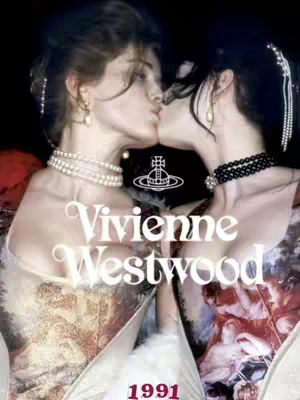 Two women are embracing and kissing, centered on a dark background, with a stylized logo and the text "Vivienne Westwood". The women are dressed in elegant attire, one with a pearl necklace and the other with a black beaded necklace.