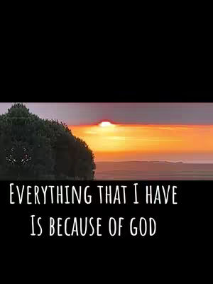 The image features a scenic sunset with a dark foreground, a vibrant sky with shades of orange and yellow. A line of trees on the left side and a text overlay at the bottom that reads "EVERYTHING THAT I HAVE IS BECAUSE OF GOD".