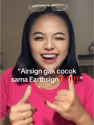 A woman with dark hair and clear glasses on her head smiles broadly, wearing a pink top. Text overlays say "Airsign gak cocok sama Earthsign!!!!!".