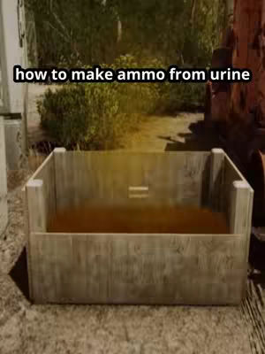A cover image for a video tutorial. The image shows a waist-high rectangular wooden container, possibly a container or trough. The container appears to hold a brown liquid filling most of its volume. Background is blurred but conveys a forest or natural outdoor setting.  The text overlayed on the image reads, "how to make ammo from urine".