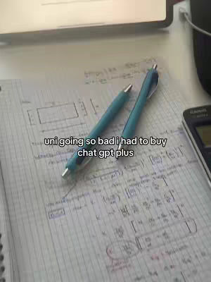 A close-up shot of a notebook with handwritten calculations and two pens lying on top. The text overlay states, "uni going so bad i had to buy chat gpt plus."
