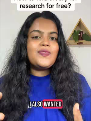 A medium shot shows a woman with dark, wavy hair looking directly at the camera. She has a fair complexion, dark eyebrows, and dark eyeliner, with medium pink lipstick. The background shows a wall and a decorative shelf. The woman is wearing a blue top, and her hands are near her face, with a red overlay. The image is well-lit, and has a casual, conversational feel.