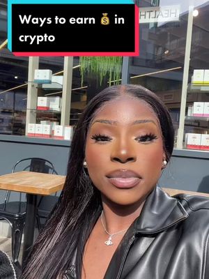 A woman with smooth, dark skin and long black hair is the primary subject. She has a soft smile and is looking slightly off-camera with a background of a cafe, with window and a table in front of her. Text overlay reads, 'Ways to earn 💰 in crypto'.