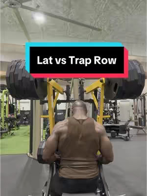 The cover image shows a man, viewed from the back, positioned in a gym setting, presumably preparing to use or already using a weight machine that includes a barbell. The man is muscled and wearing a tank top. The setting is a gym environment with exercise equipment and other gym users visible. There's text overlaid, the main text is a hook which says 'Lat vs Trap Row'.