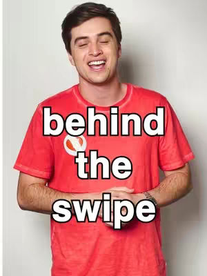 The cover image features a smiling man with dark hair, wearing a red t-shirt, set against a plain white background. Text overlayed on the image reads \"behind the swipe\".