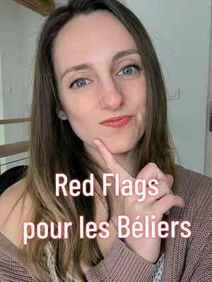 A selfie-style shot of a woman looking at the camera with her index finger touching her lips. White text overlays the image. The woman has light skin, long brown hair, and blue eyes. She is wearing a brown sweater.