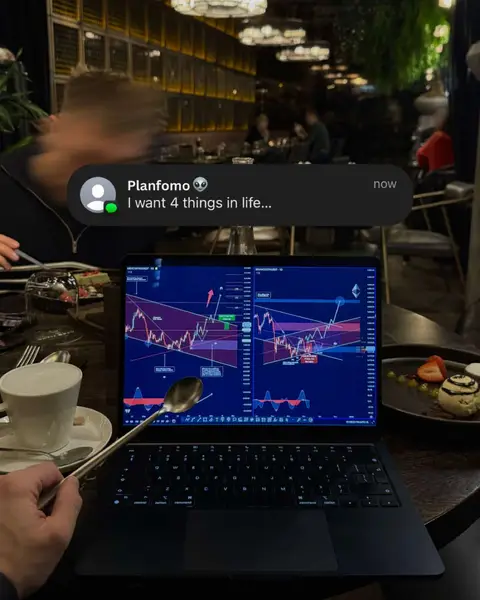 A person is sitting at a restaurant table with a laptop displaying a crypto trading chart. There is a coffee cup, spoon, and dessert on the table. A notification appears on the image.