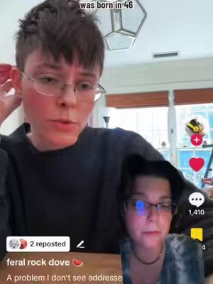 A person with short hair and glasses is looking at the camera inside a room. There is a smaller inset video beneath the person.