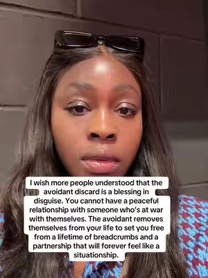 A close-up shot of a dark-skinned woman looking directly at the camera. She has long, dark hair and is wearing a black frame sunglasses on her head. A text overlay sits in front of her.