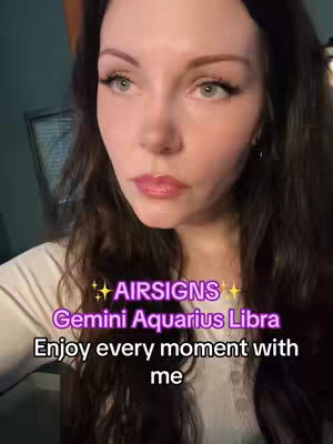 A woman with long brown hair is centered in the frame, looking towards the left. The background is slightly blurred. A text overlay at the bottom features the words 'Enjoy every moment with me' in a white font. 'Airsigns Gemini Aquarius Libra' is written in purple above is the creator’s face, with a light skin tone and natural makeup.