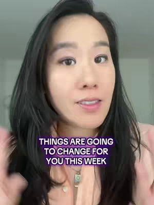 A woman with dark hair is centered and smiling, against a bright, blurred background. Text overlayed in purple reads, “THINGS ARE GOING TO CHANGE FOR YOU THIS WEEK”. A pendant hangs from a delicate necklace.