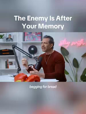 The cover image shows a man in a maroon sweater speaking into a microphone in a well-lit room. To the left of the man are red boxing gloves.
