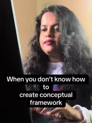 A woman with long, dark, wavy hair is centered in the shot, looking slightly down, her expression focused. She has light skin, with a subtle lip color. Vertical black text overlays at the bottom describe creating frameworks.