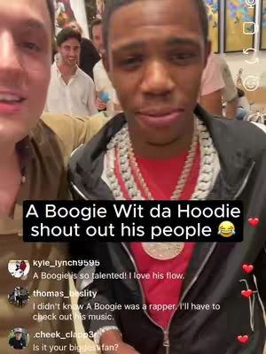 The cover image is a selfie-style video with a focus on two men. The main subject, is a man with a black jacket, a red shirt, and a large chain necklace. The overlay text explains someone is shouting out his people. The background includes a group of people.