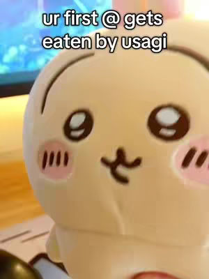 The cover image features a close-up of an Usagi plushie with a text overlay. The plushie is tan with pink cheeks and dark eyes. The text overlay says, "ur first @ gets eaten by usagi." The image is brightly lit.