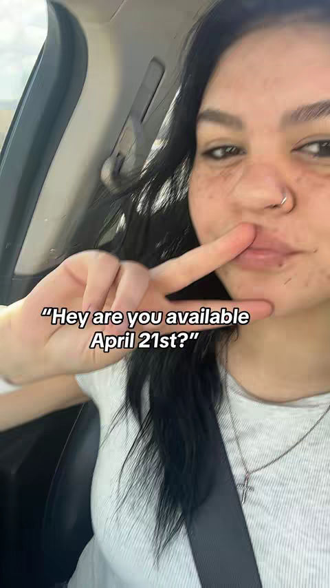 A selfie taken inside a car with the driver using the peace sign with their fingers and a text overlay indicating a question about availability on April 21st.