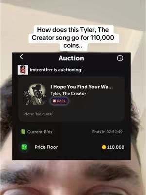 The cover image shows a close-up of a person's face, with the forehead and eyes visible, and the UI of a music app superimposed over it. The app interface shows details of a song titled 'I Hope You Find Your Wa...' by Tyler, The Creator, within an 'Auction' interface.