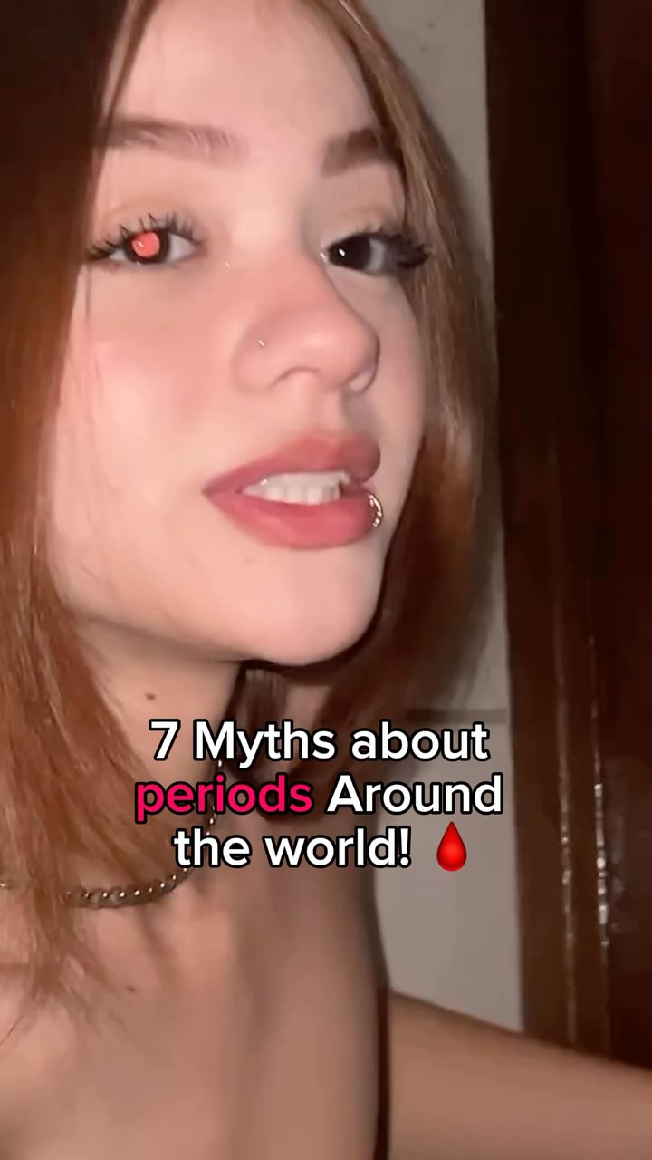 A close-up shot of a woman with long reddish hair against a blurry background. She has a nose ring and a lip ring. Overlay text provides the video's main subject.