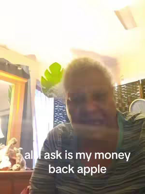 The image features a woman in a close-up shot, with text overlaid at the bottom. The background is a room with visible elements like a curtain, a mirror, and a leaf. The woman appears to be indoors, with the lighting suggesting an indoor setting.