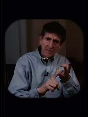 A man in a blue shirt is speaking with his hands in front of him, the image is within a darker frame with the word 'friends' in white text.