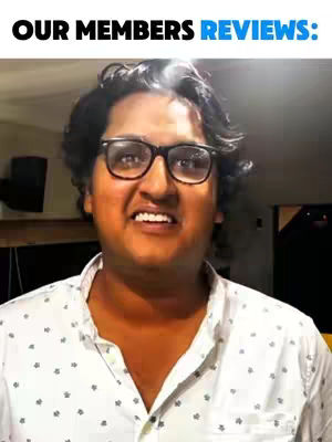 The image shows a man with glasses making a slightly strained facial expression. Above him, the text 'OUR MEMBERS REVIEWS:' appears in a bold font. The background looks like a room, possibly an office or home setting.