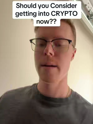 The cover image features a man, viewed from the upper chest up, set against a plain wall. He wears eyeglasses and a gray t-shirt. Above him is a white rectangular text overlay with the question, 'Should you Consider getting into CRYPTO now??'